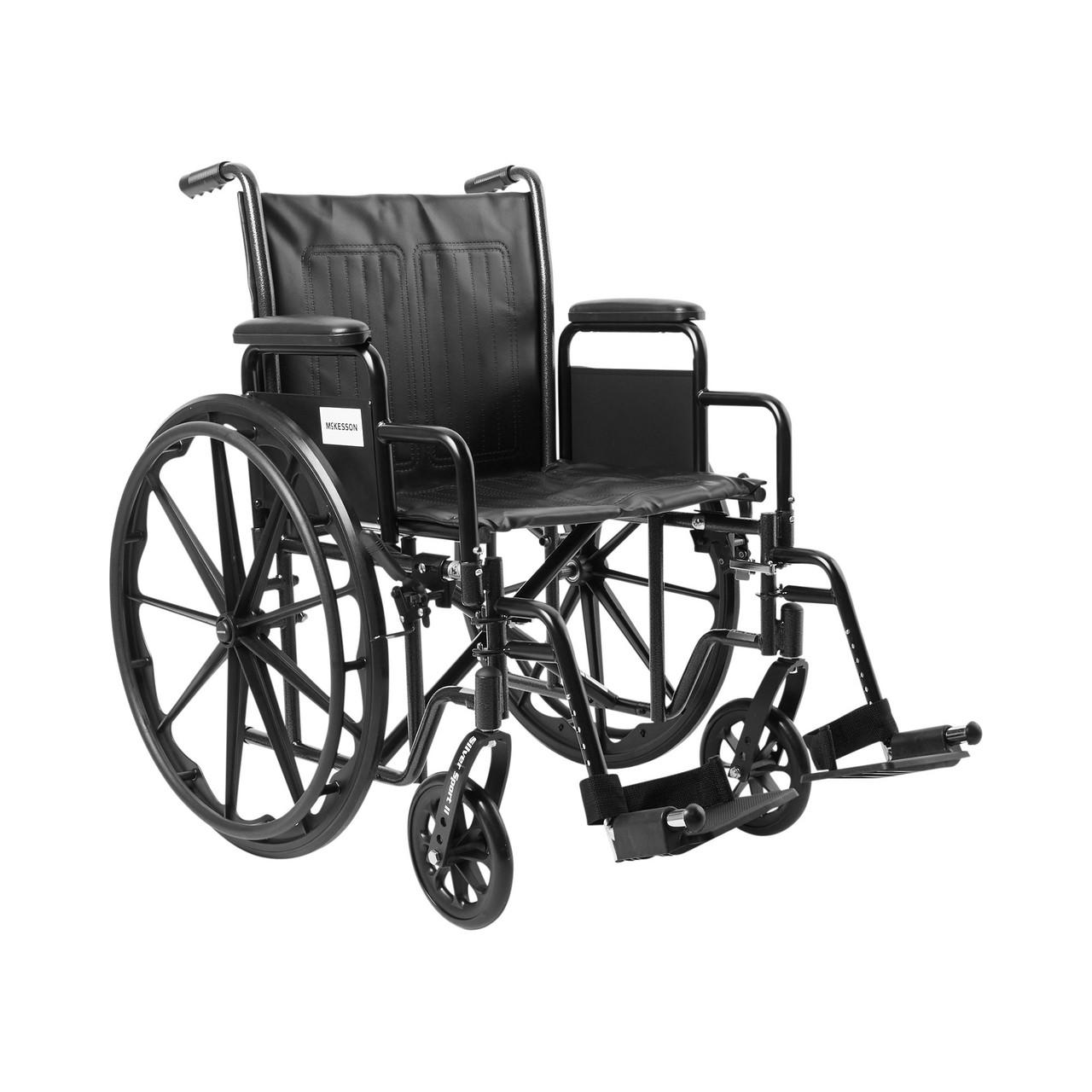 Black 20-inch wheelchair with swing-away footrests and detachable desk arms, padded seat