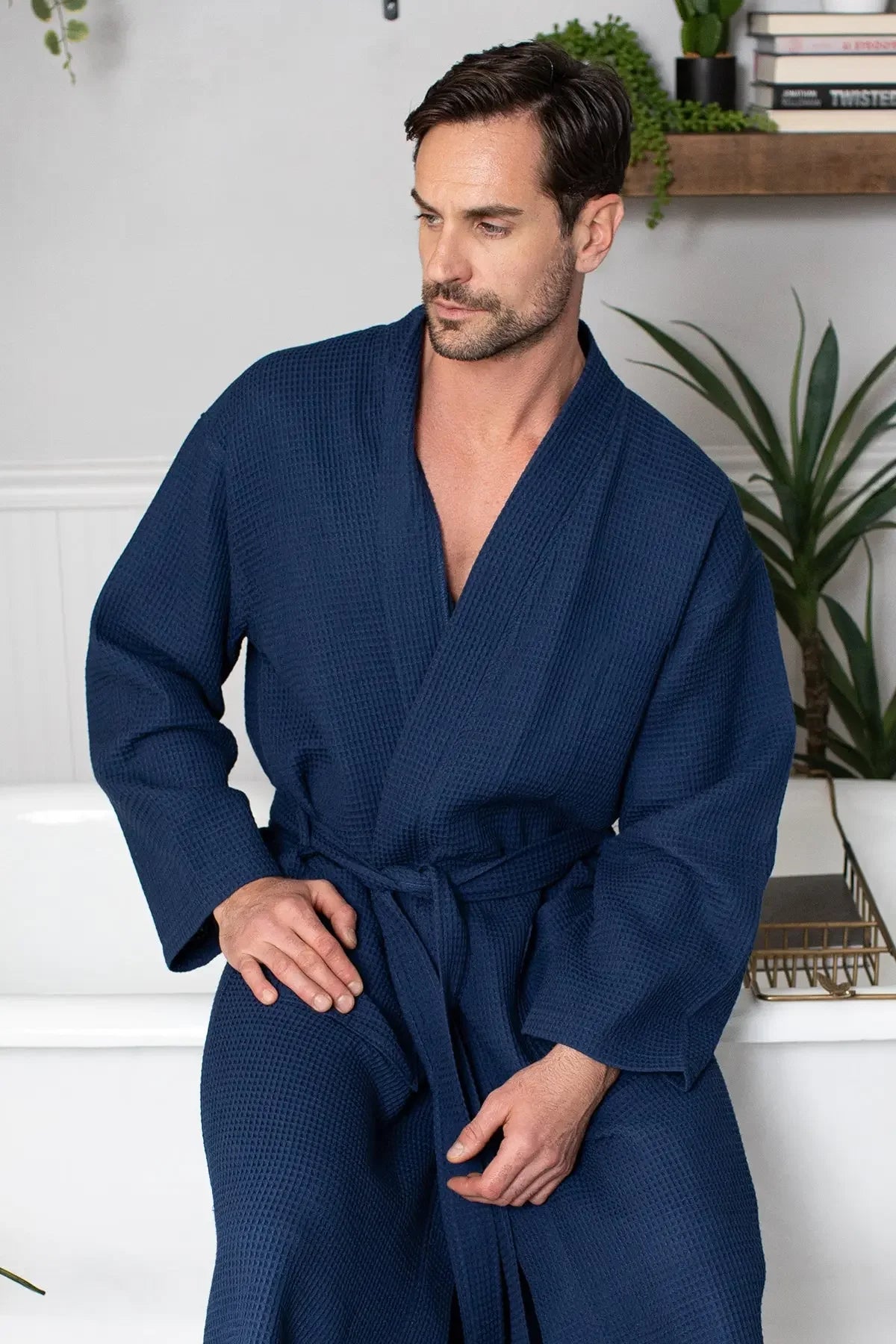 Men's waffle spa bathrobe in navy blue, V-neck waffle-knit with belt and long sleeves.