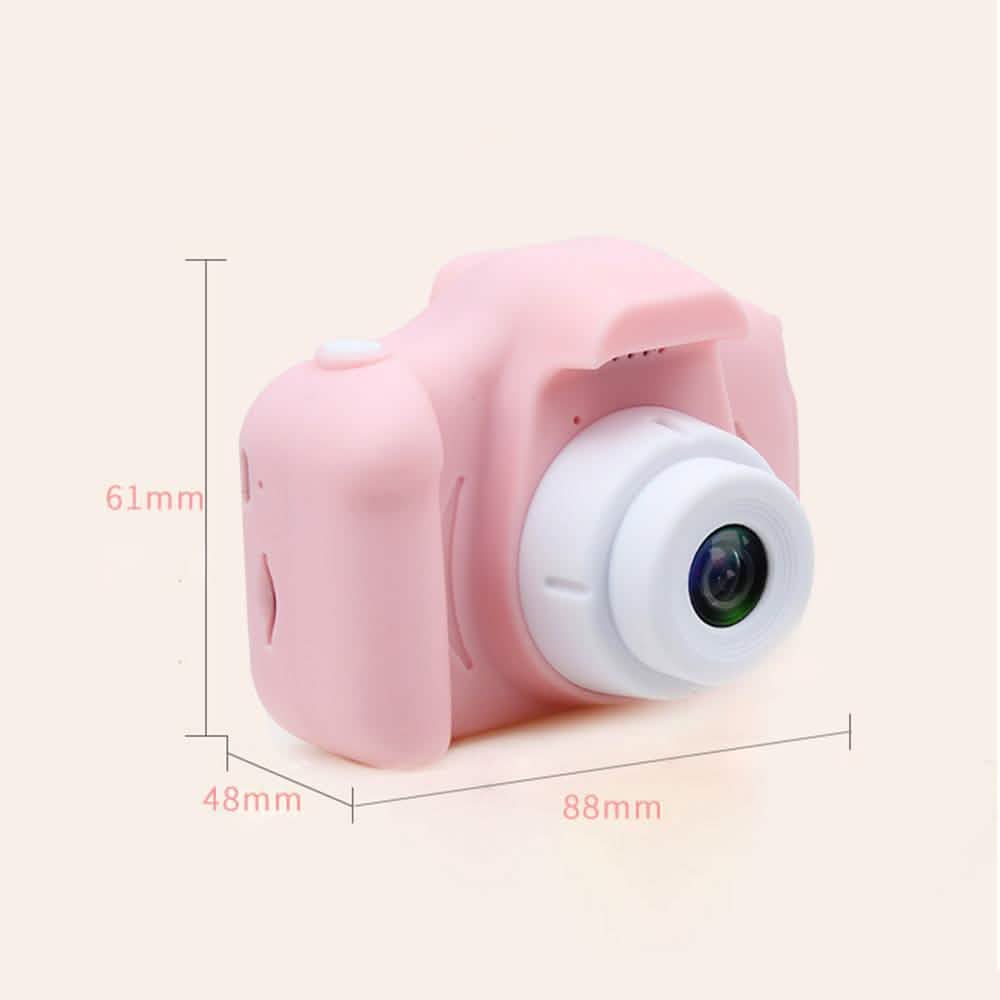 Pink mini children's digital camera with prominent white lens housing
