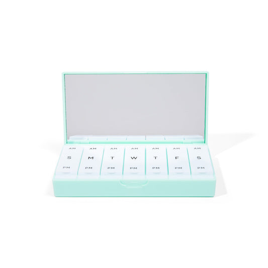Mint pill box open with white weekly slots labeled AM and PM