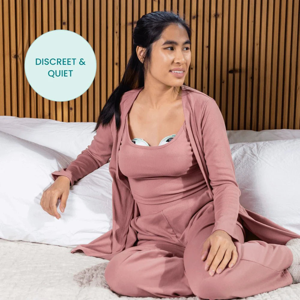 Wearable breast pump worn under clothing with a discreet, low-profile pump dome