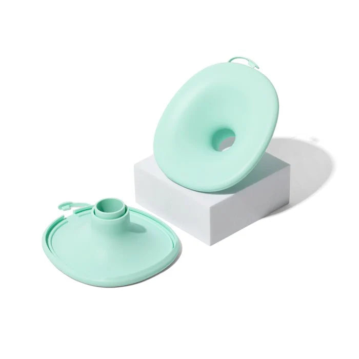 Wearable breast pump in mint green: circular flange and lid-style motor unit
