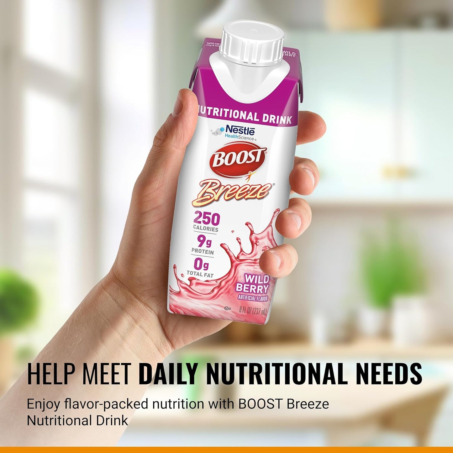 Hand holding Boost Breeze wild berry nutritional drink carton with cap and front label