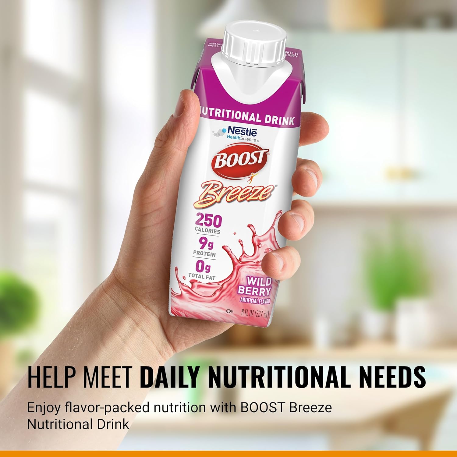 Hand holding Boost Breeze wild berry nutritional drink carton with cap and front label