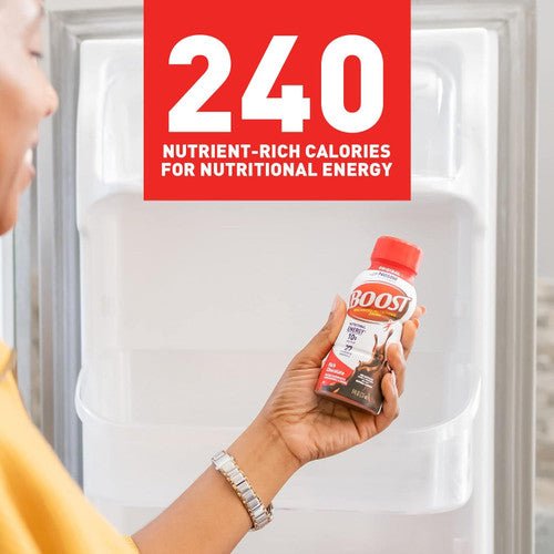 Hand holding Boost Original rich chocolate bottle with 240 calories callout