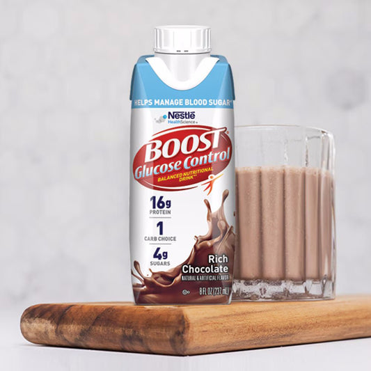Rich Chocolate glucose control drink bottle beside a glass of chocolate shake