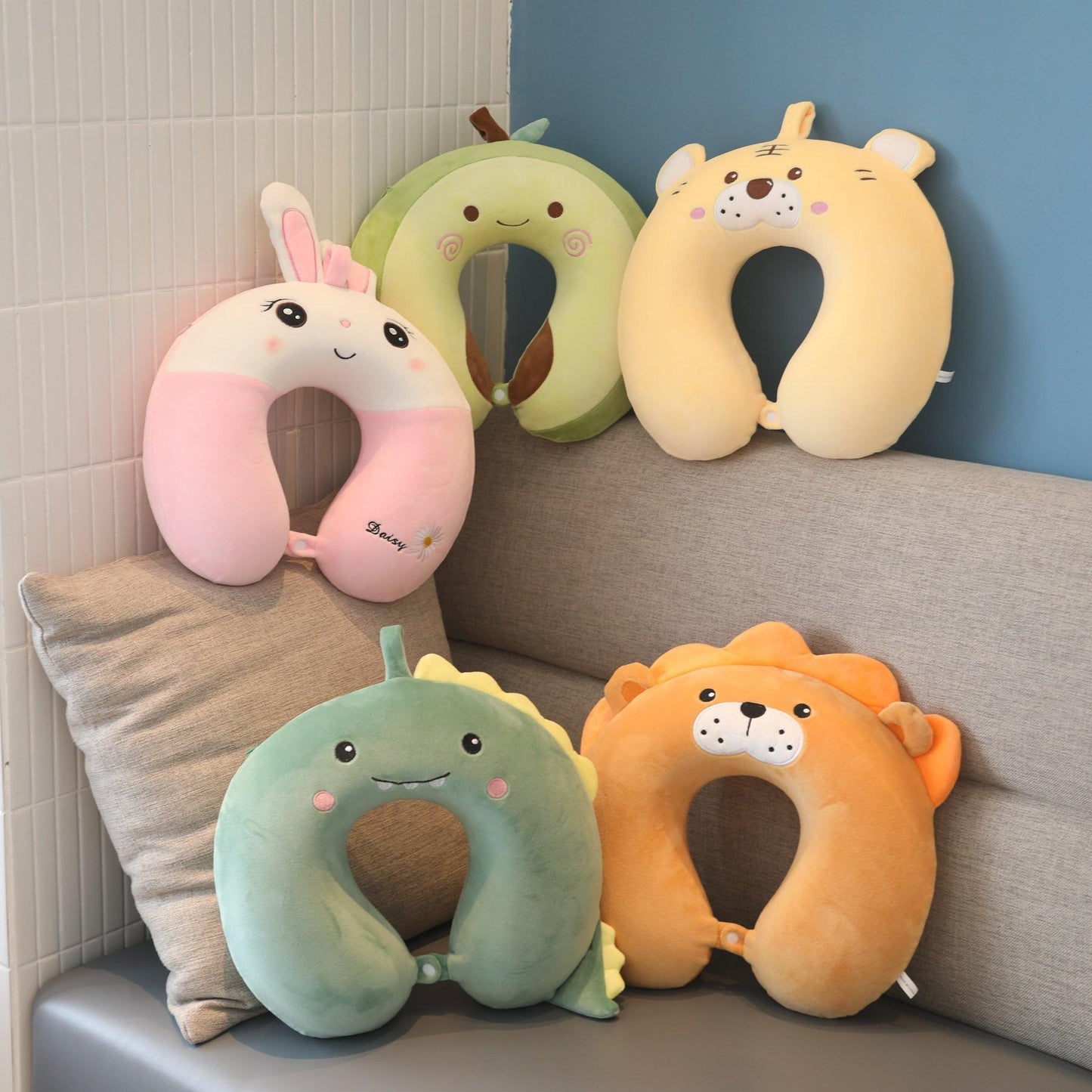 Kids U-shaped animal neck pillows: pink bunny, green frog, orange lion, beige dog