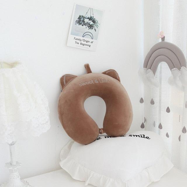 Brown U-shaped animal neck pillow with simple face and rounded ear accents