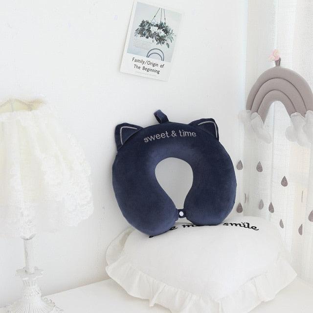Navy U-shaped cat neck pillow with stitched eyes, ears, and embroidered face