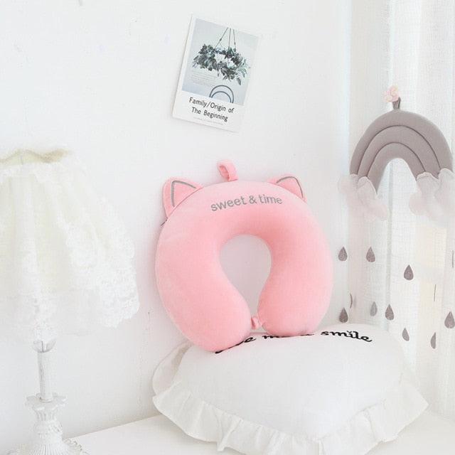 Pink U-shaped cat neck pillow with ears and embroidered smile, soft plush