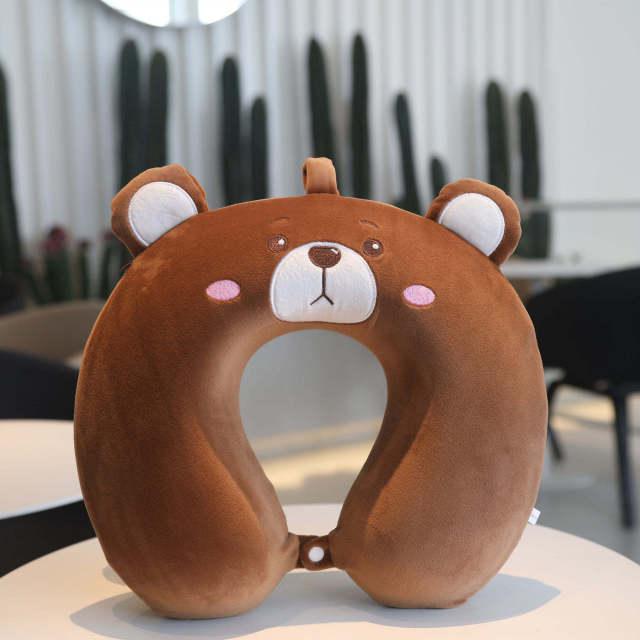 Brown U-shaped bear neck pillow with white muzzle and stitched smile