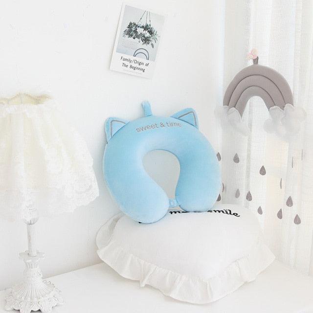 Light blue U-shaped cat neck pillow with embroidered face and small ears