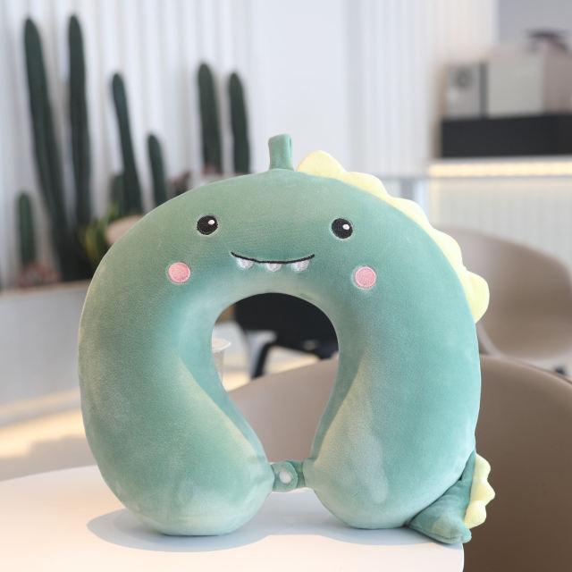 U-shaped plush animal neck pillow, green dinosaur with stitched smile and spikes