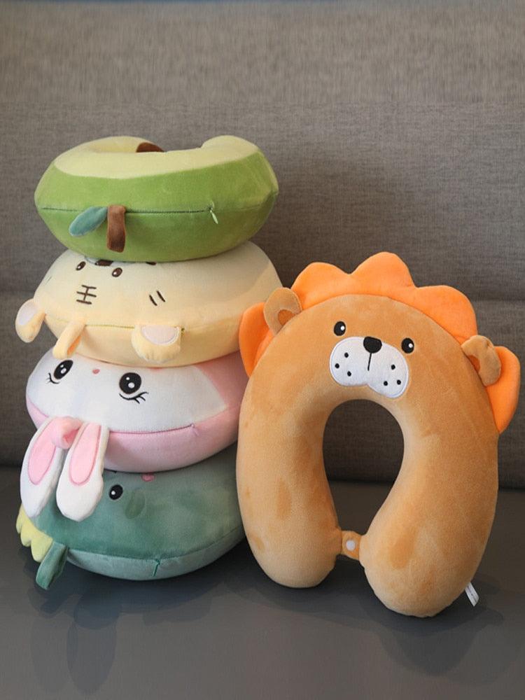 Assorted U-shaped animal neck pillows set with cute faces in green, white, and orange