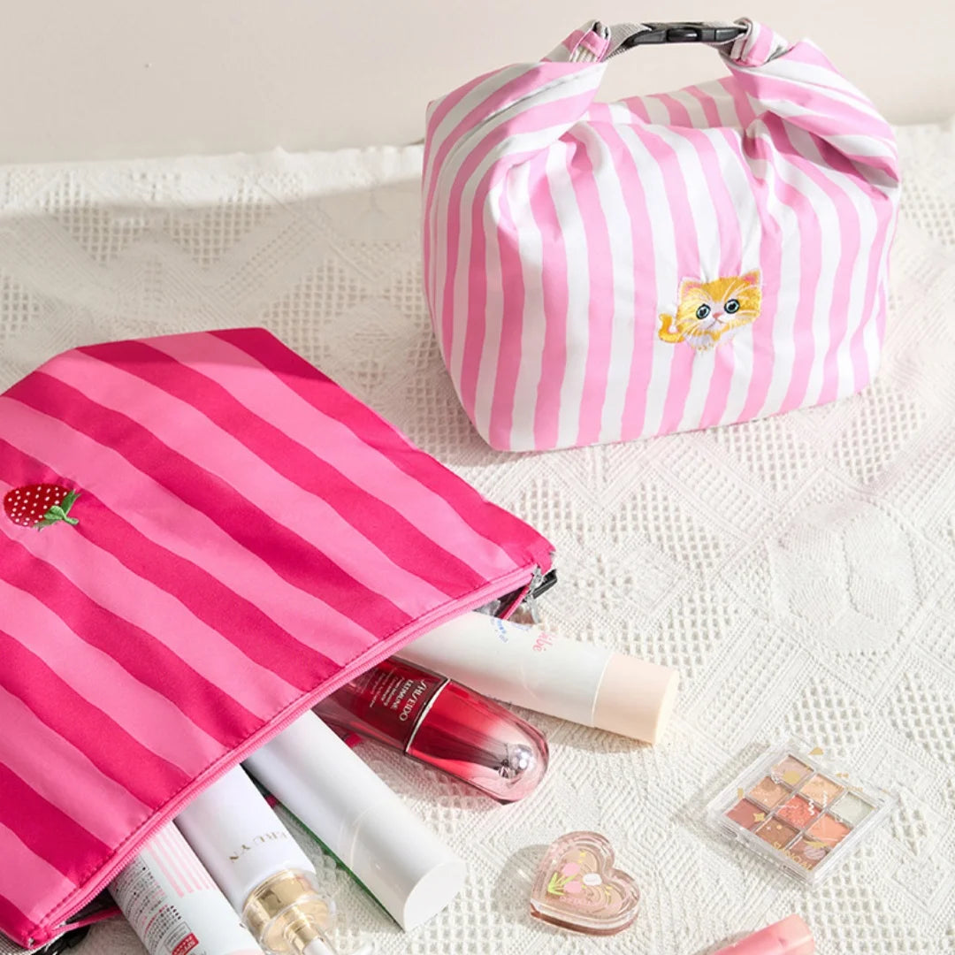 Open pink and white striped insulated lunch bag with cat patch and carry handle
