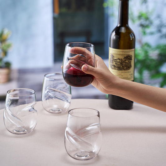 Stemless acrylic wine glass with finger indent, clear cup held in hand