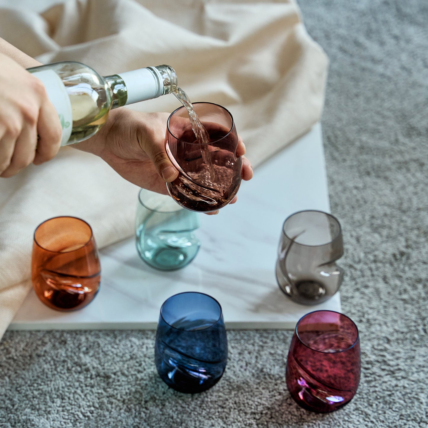 Set of 6 acrylic stemless wine glasses, finger-indented bowls, with one being filled