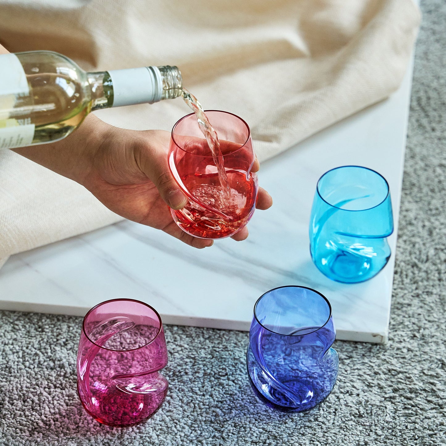 Stemless acrylic wine glasses set of 4 with finger-indent cups, red, blue, and pink filled