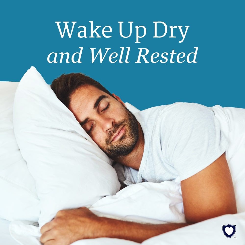 Person resting in bed with a light blue washable underpad placed on the mattress