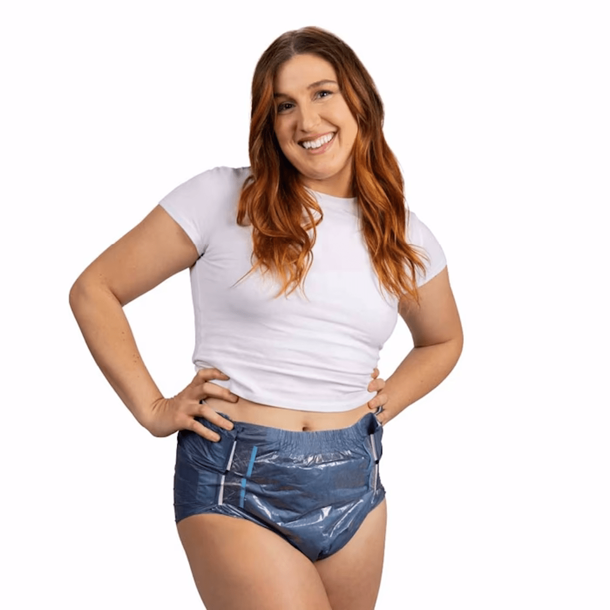 Blue tab-style adult brief on woman in white top, hands on hips