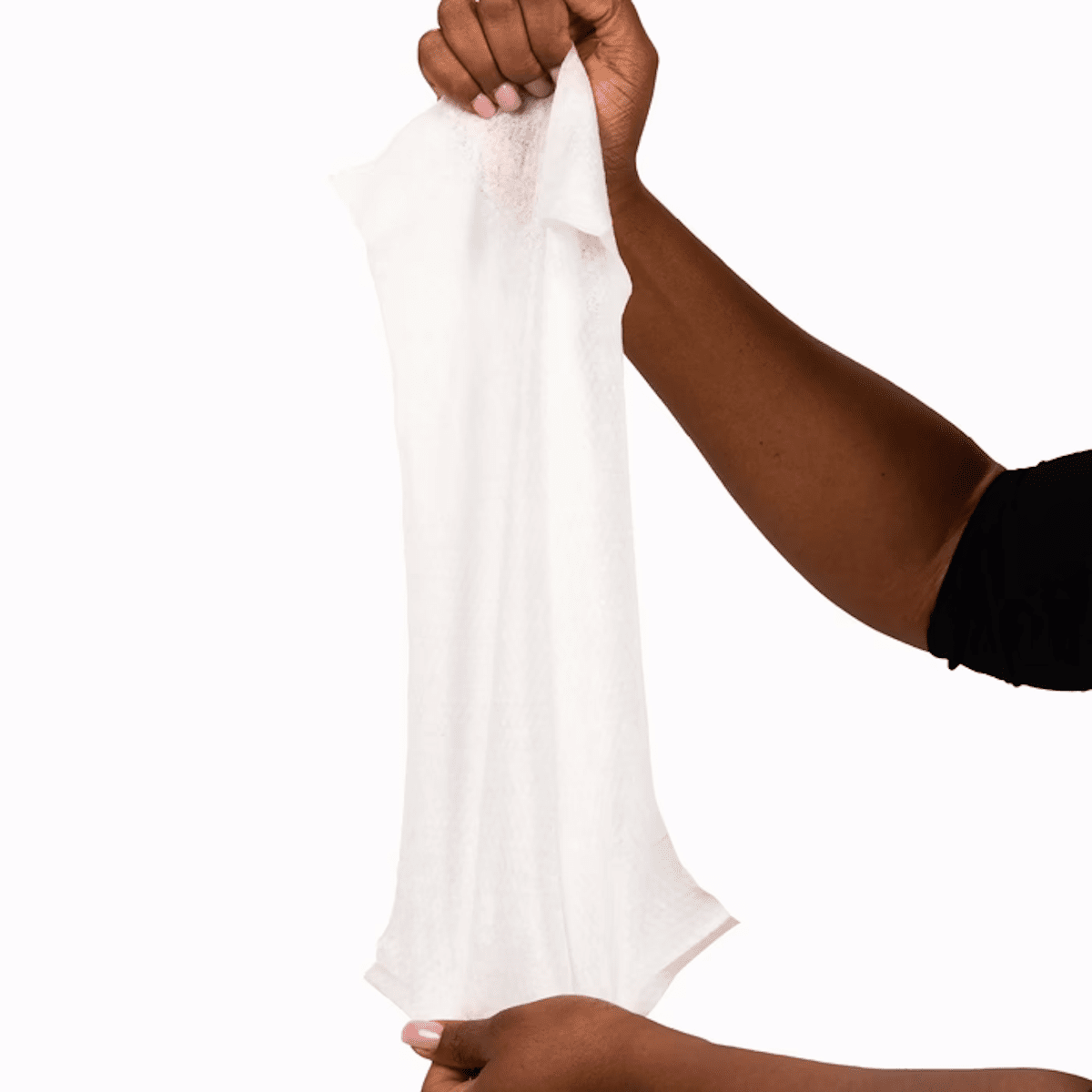 Hands pulling a long white cleansing wipe from a stack