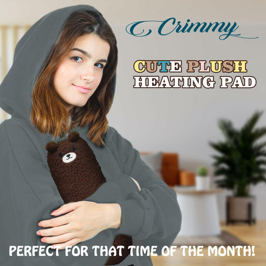 Plush bear USB heating pad tucked against a person for warmth during cramps
