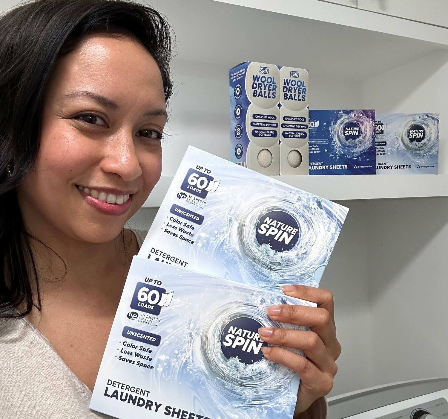 Person holding Nature Spin unscented laundry detergent sheets boxes