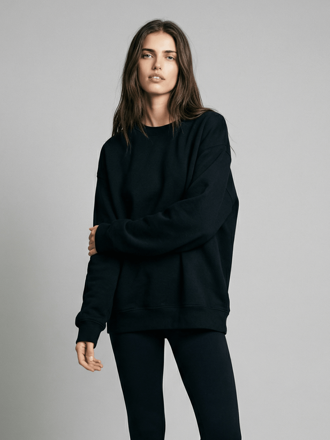 Dark crewneck sweatshirt with long sleeves and ribbed hem detail