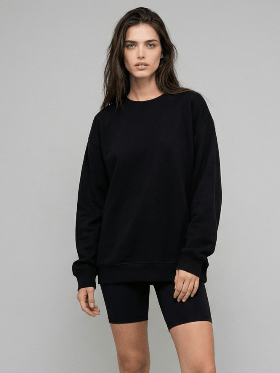 Black crewneck sweatshirt with ribbed cuffs and waistband hem