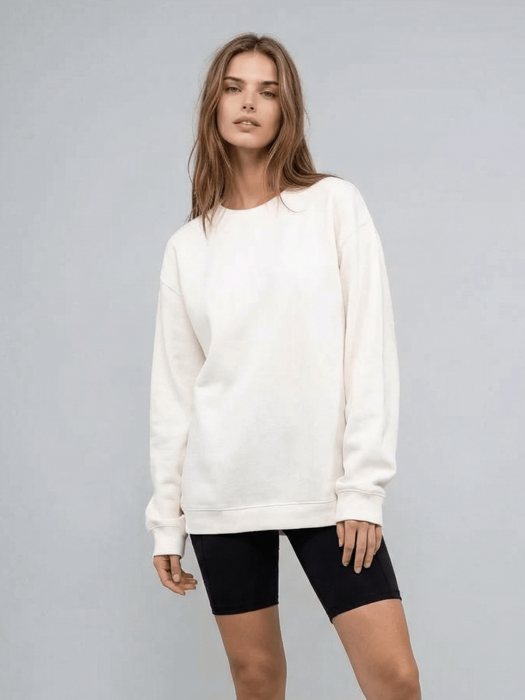 White crewneck sweatshirt with long sleeves and ribbed waistband hem