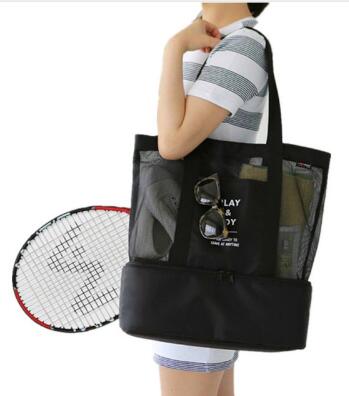 Black insulated cooler tote held by a person, open mesh front organizer