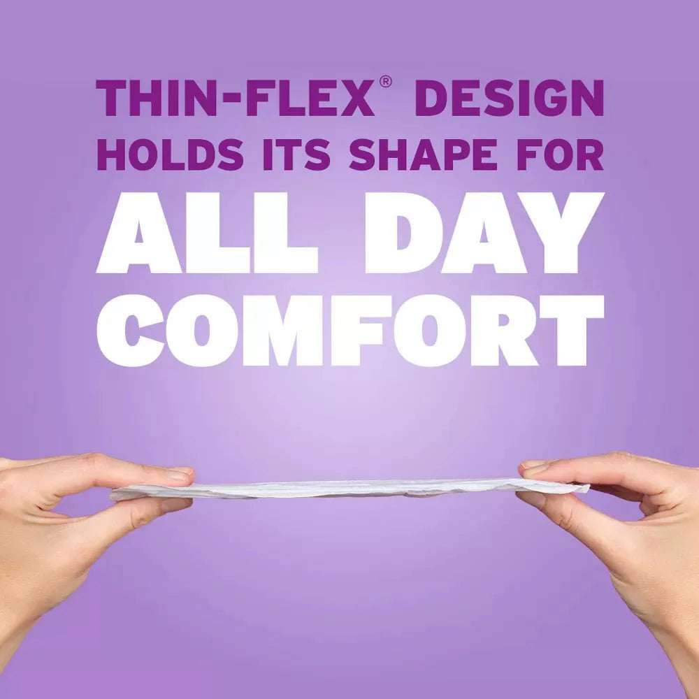 Hands holding a thin-flex regular pad strip labeled for all-day comfort