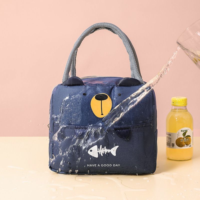 Insulated lunch cooler bag in dark blue with cartoon bear face and gray handles
