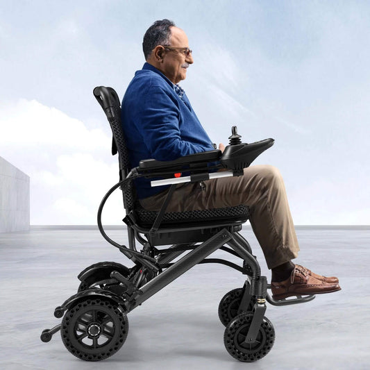 Electric wheelchair in black showing side profile, footrests and large caster wheels