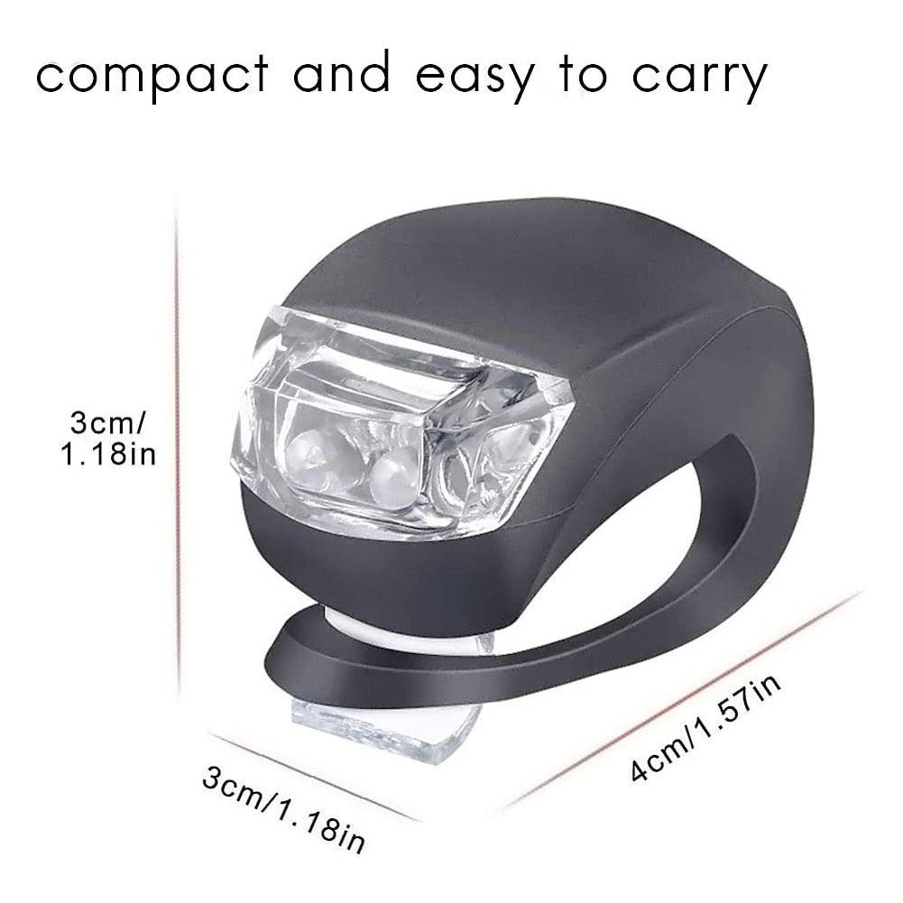 Compact mini bike headlight with clear lens, black silicone housing, and mounting band
