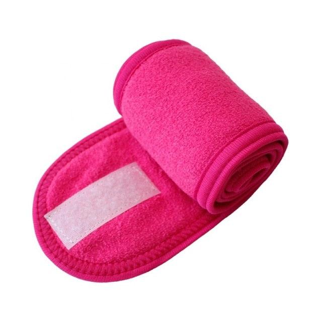 Pink terry cloth face-washing headband with white center stripe and rolled edge