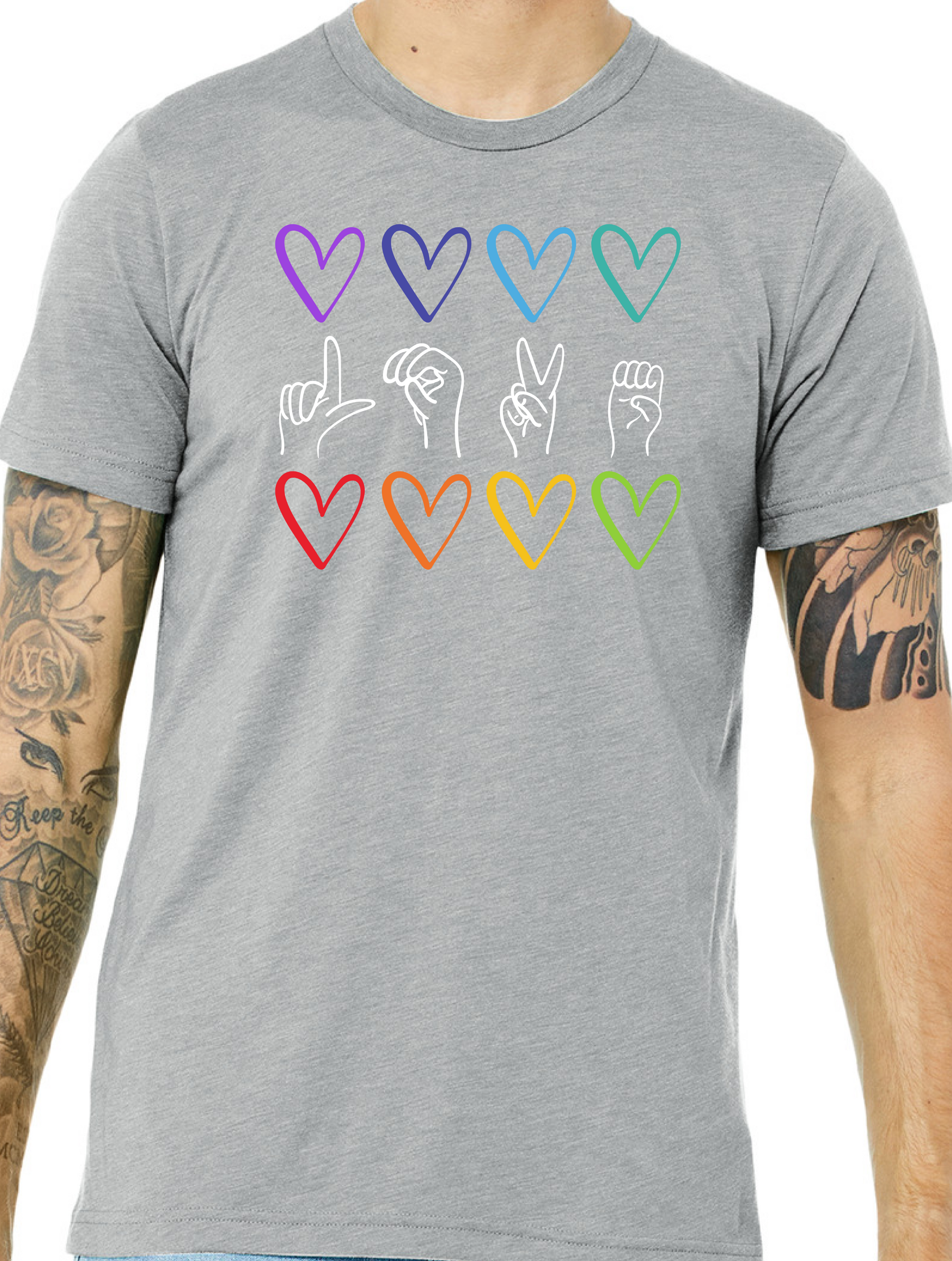 Gray t-shirt with colorful heart and hand design on a person wearing tattoos.