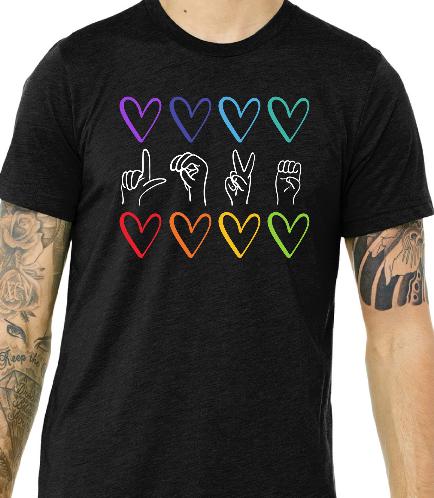 Black t-shirt with colorful heart and hand sign designs on a white background
