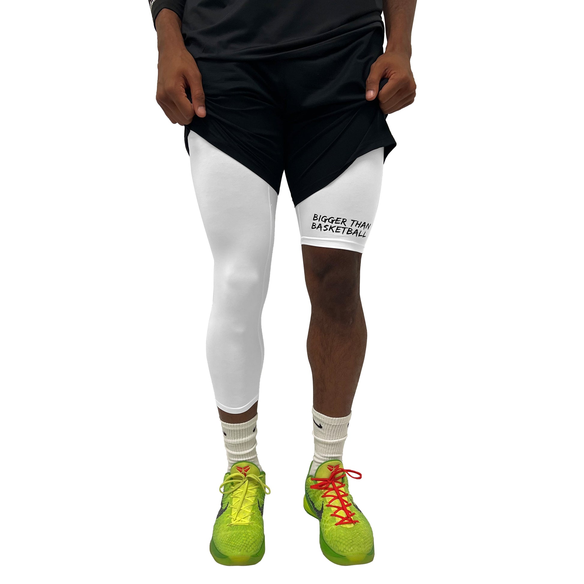 Right white compression tights worn on model, full-length with brand graphic