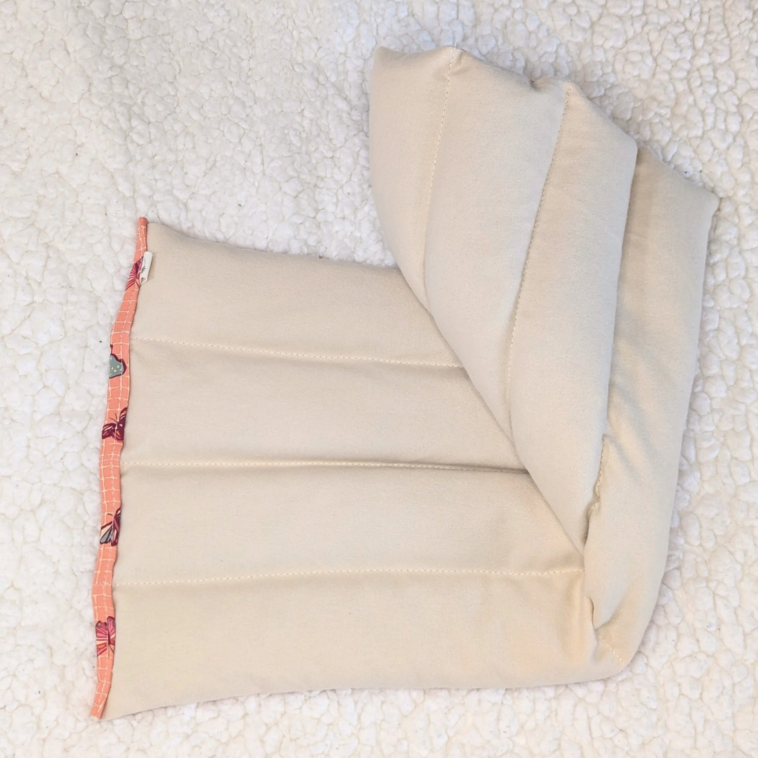 Weighted heating pad folded, smooth cream flannel back with stitched channels