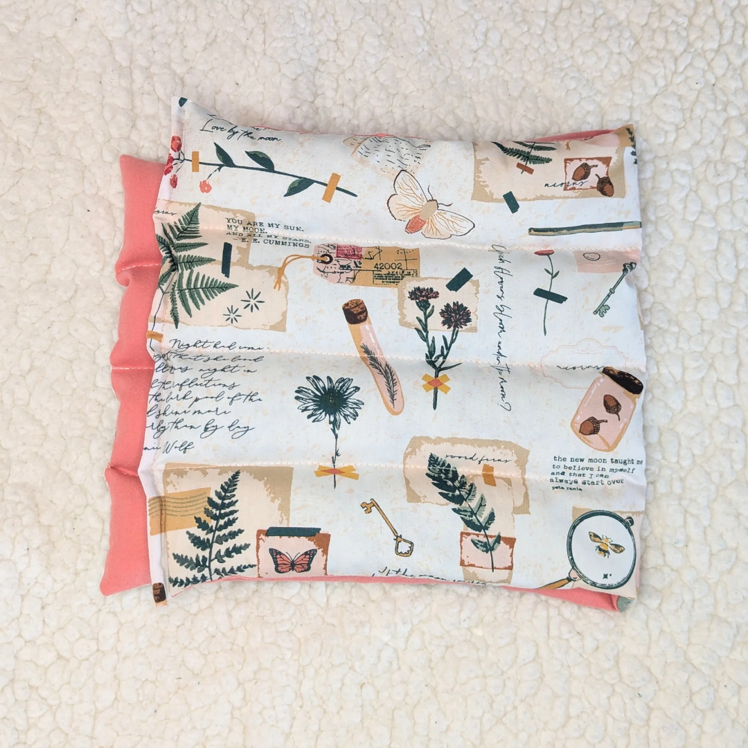 Weighted heating pad with Field Diary print cover and pink flannel backing