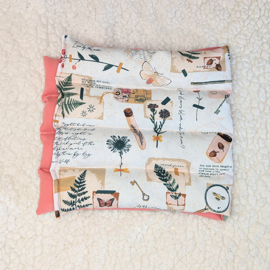 Weighted heating pad with Field Diary print cover and pink flannel backing
