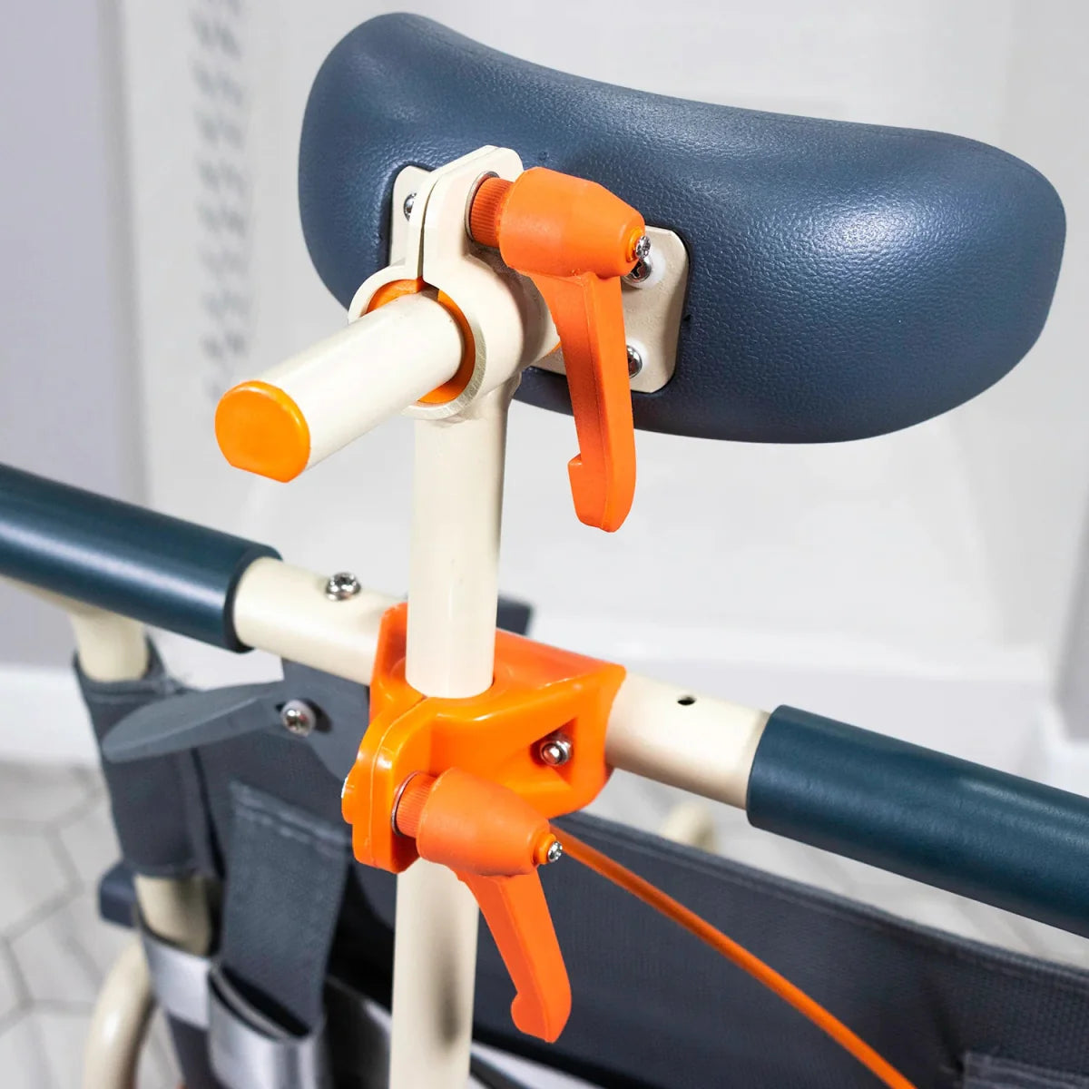Close-up of dark blue headrest on shower chair with orange adjustment lever