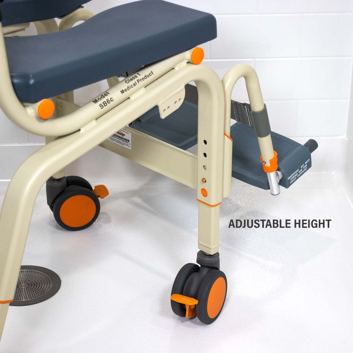 Close-up of shower chair frame with model label, adjustable height and orange wheel
