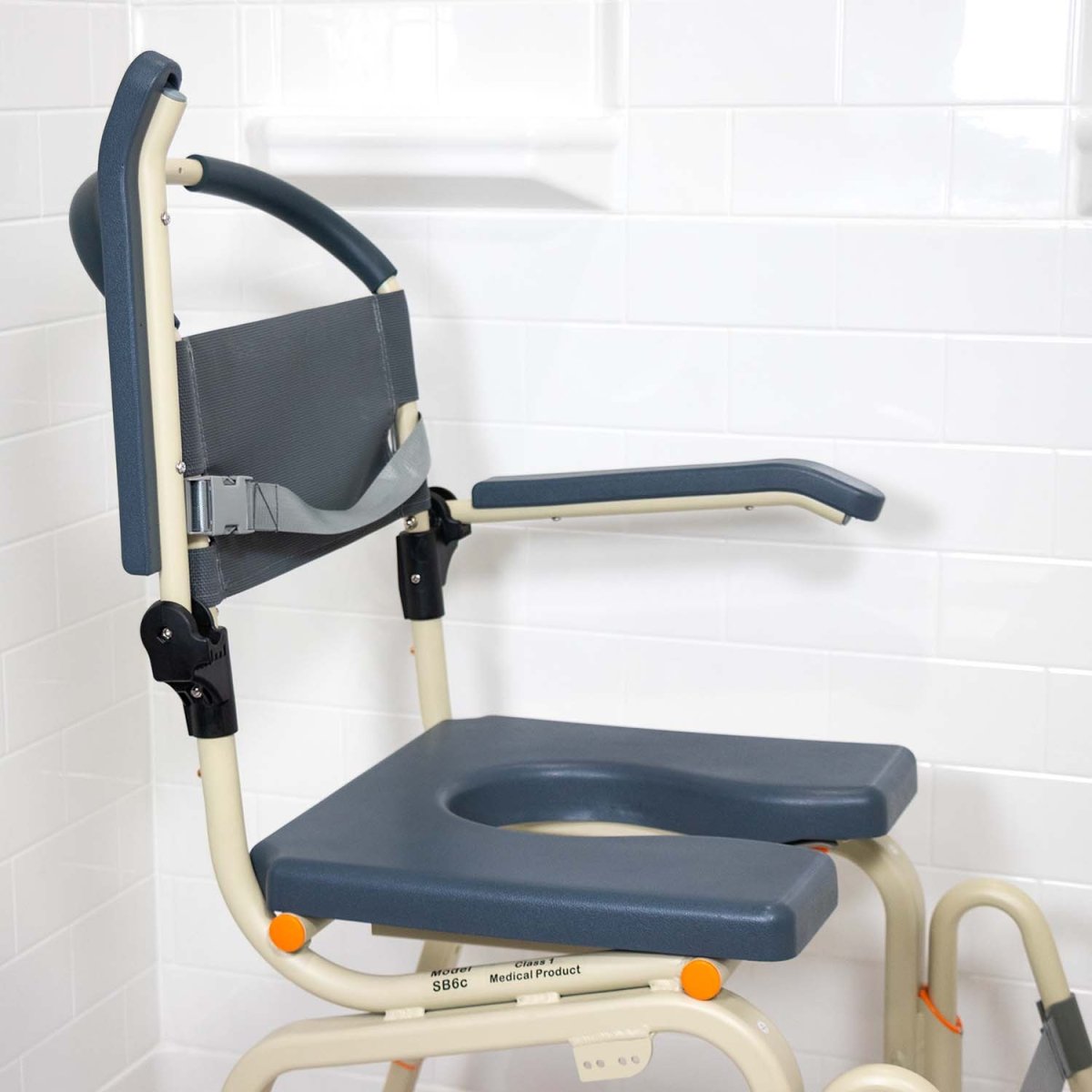 Roll-in shower chair side view with blue seat, backrest, and navy handle