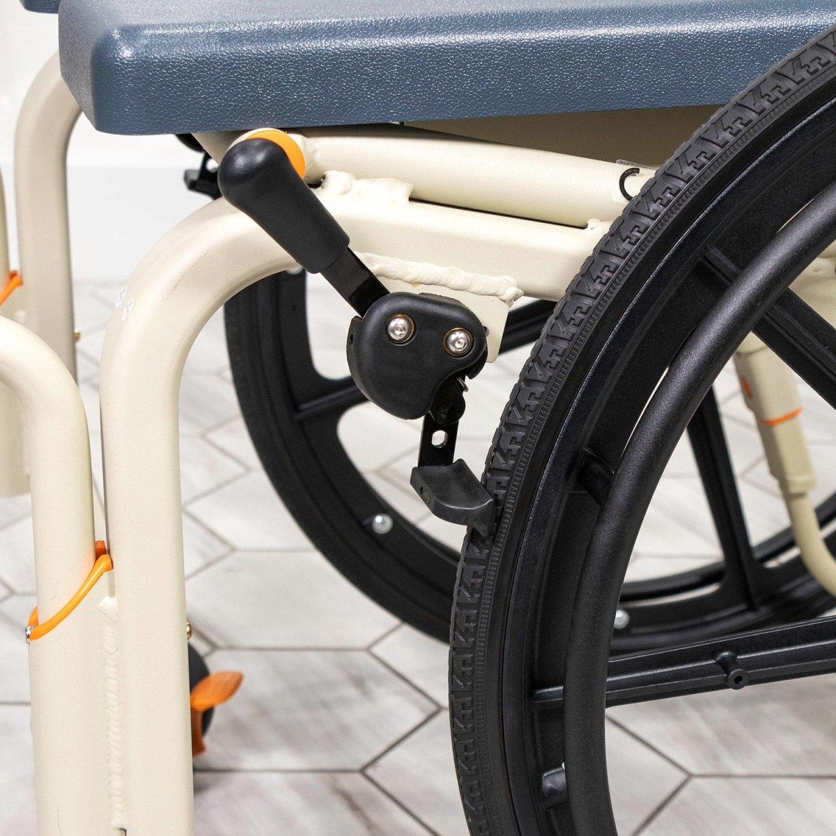 Close-up of wheelchair rear wheel and frame with textured tire for shower use
