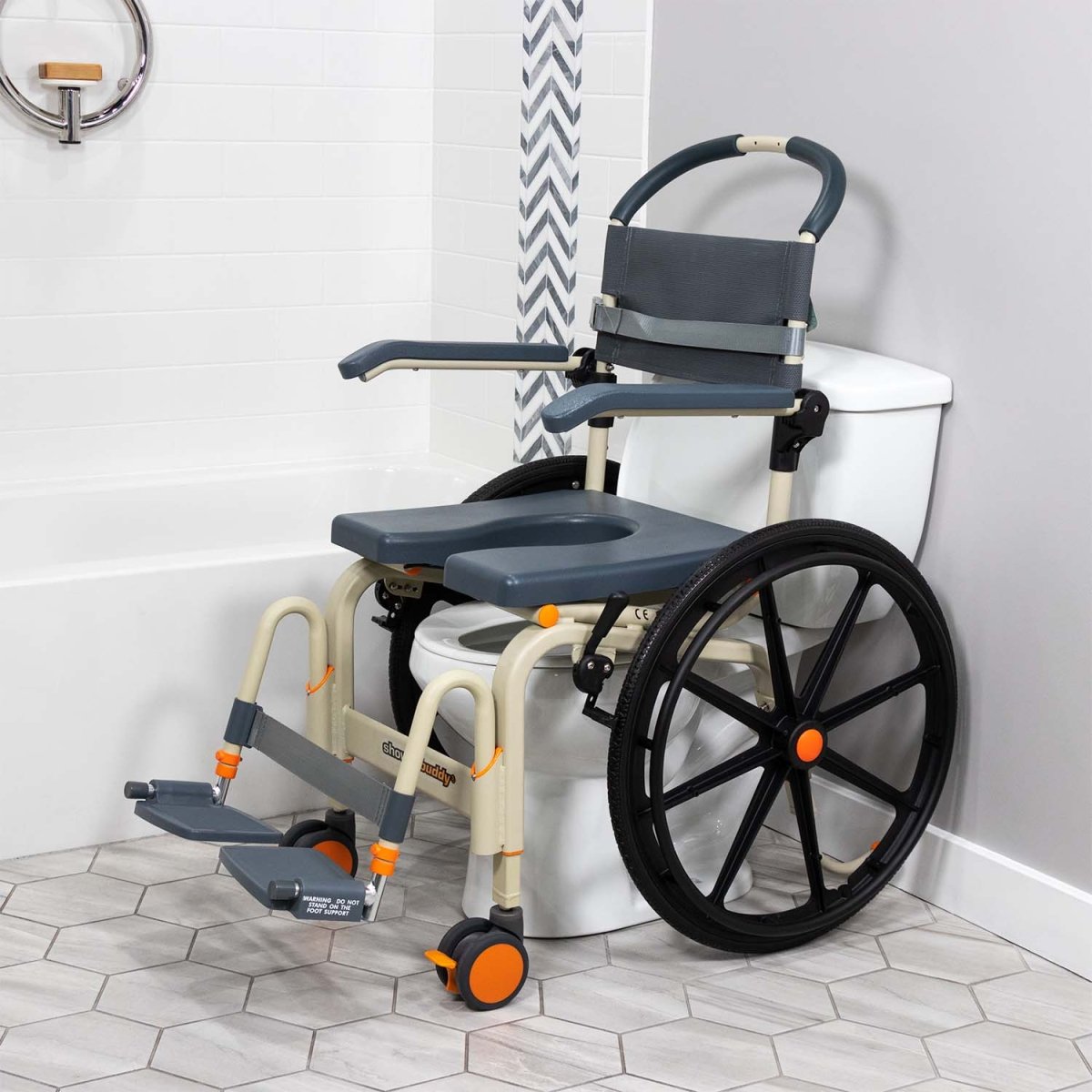 Shower wheelchair with foot support platform, padded backrest, and blue seat with cutout