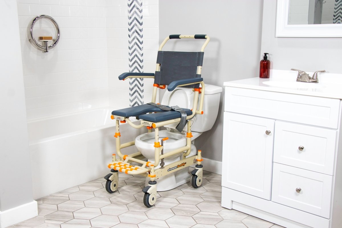 Shower chair with blue seat pads, armrests, and back handle over toilet
