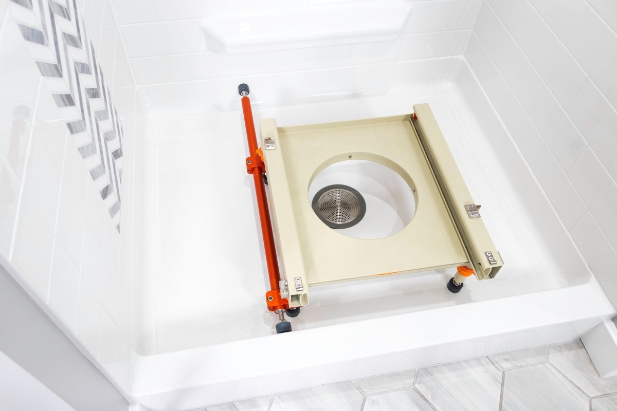 Rolling shower chair over-toilet base with orange handle and wheeled brackets
