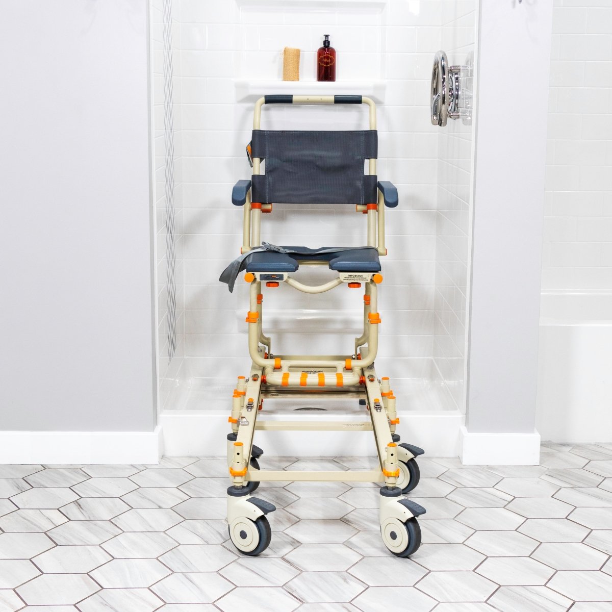 Shower chair in bathroom: navy padded seat and back, cream frame, orange height legs, wheels